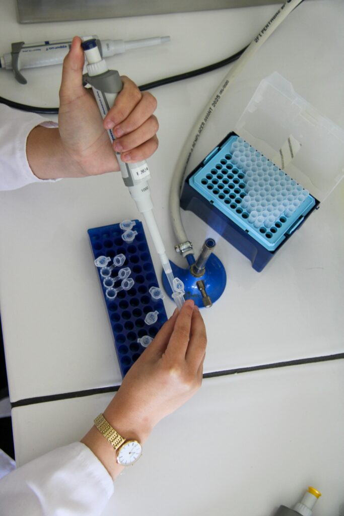 Researcher using a pipette in a laboratory